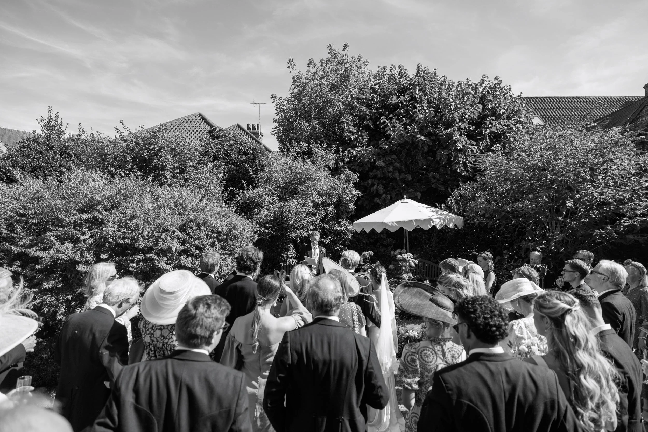 Black and white photograph capturing the relaxed atmosphere of Alicia and Max's reception.