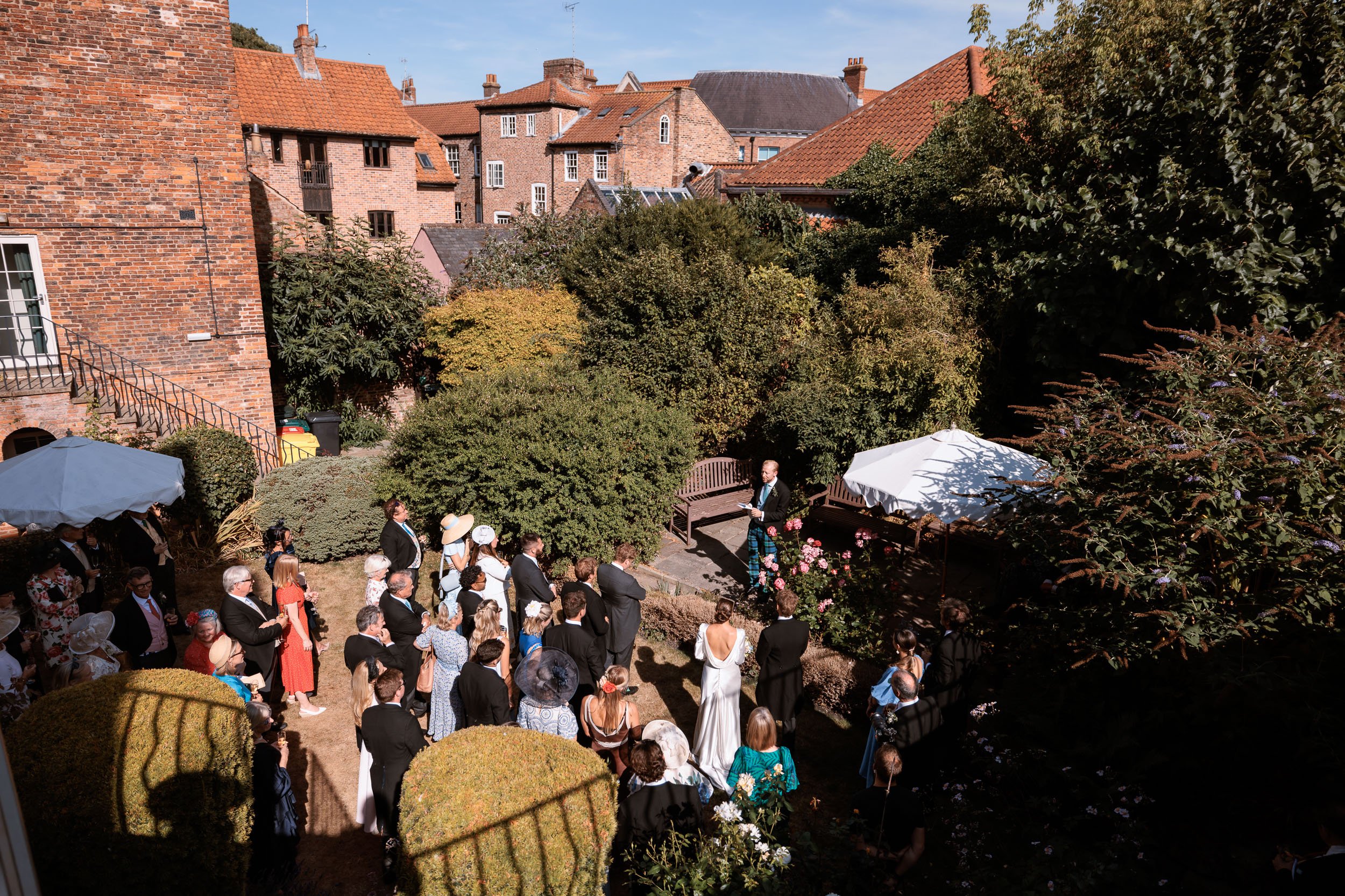 Elevated view across the garden during Alicia and Max's wedding reception.