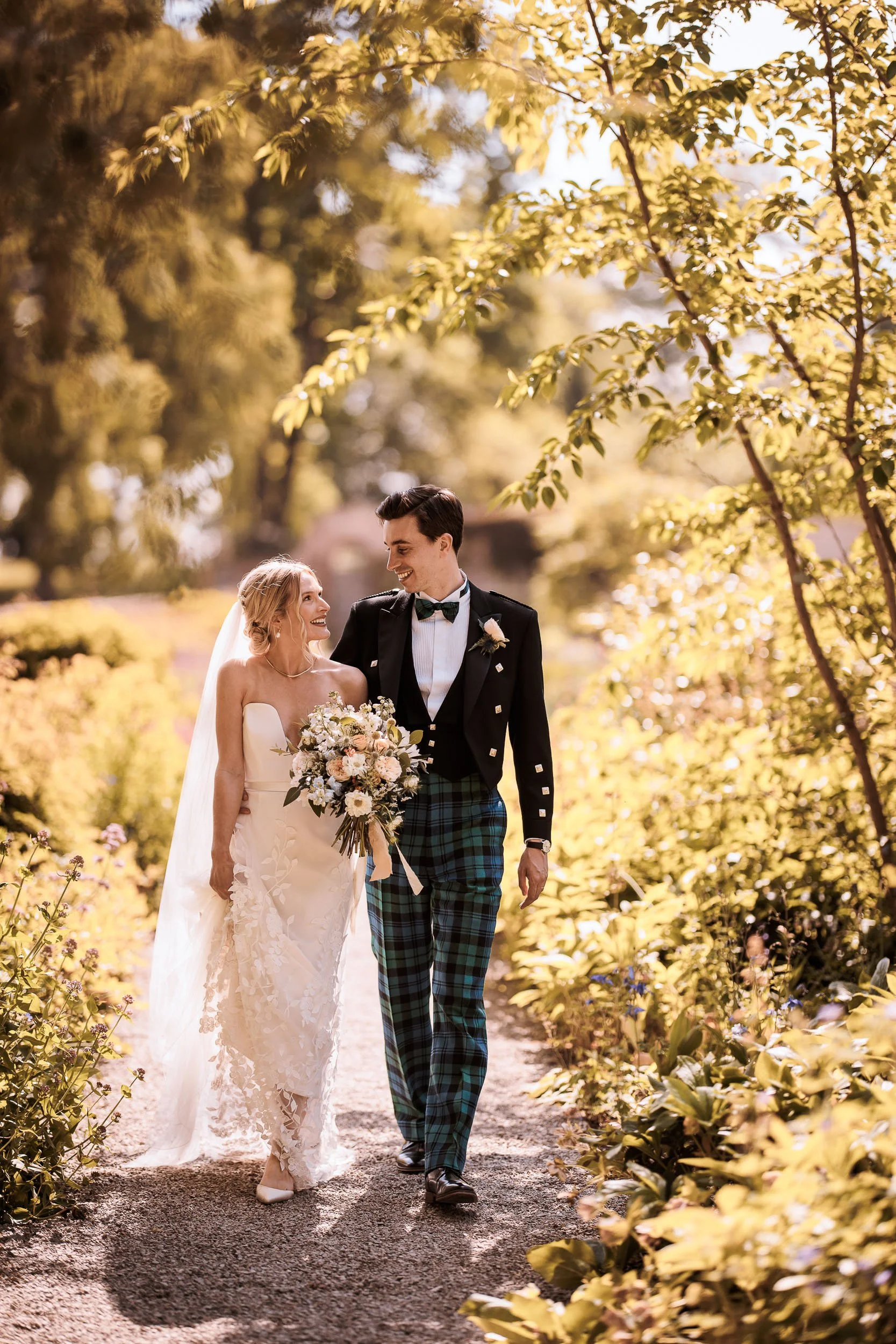 Newlyweds walking through autumn woodland at Middleton Lodge.
