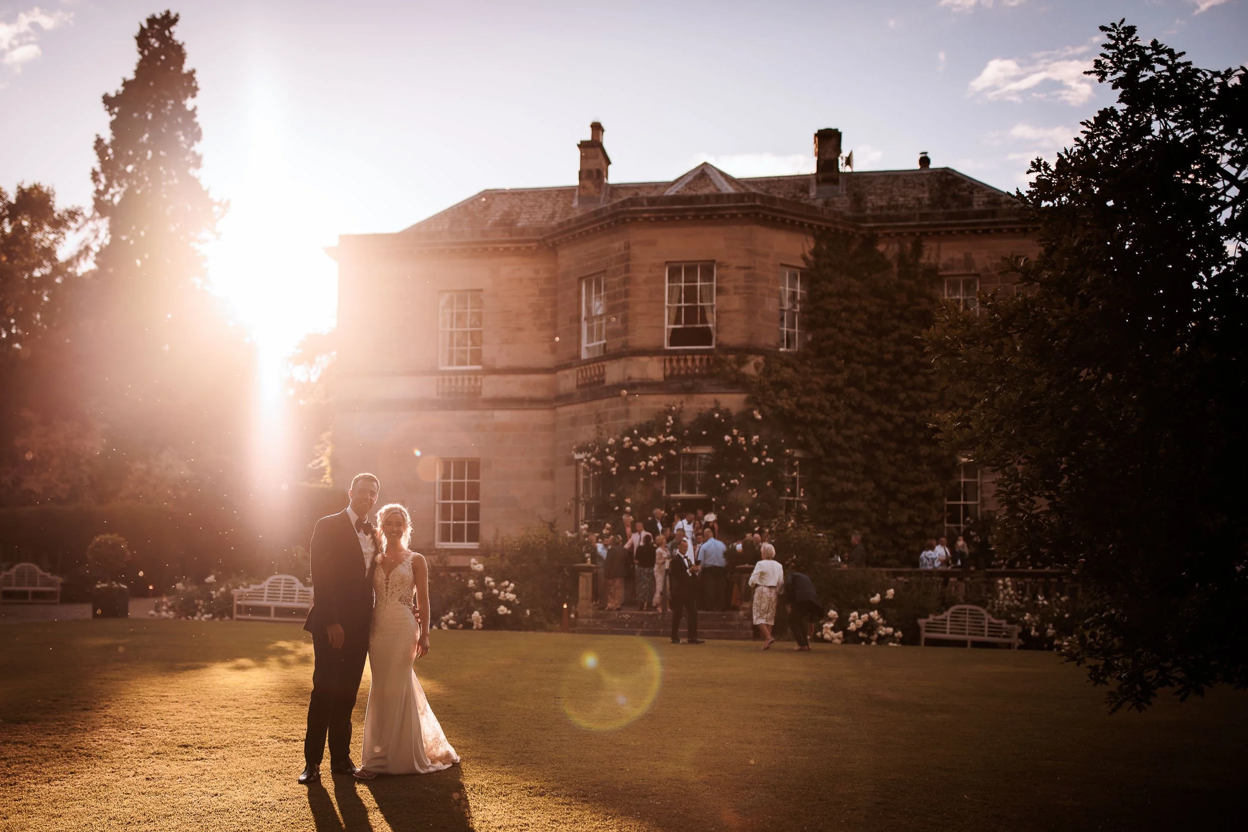 Newlyweds at sunset beside Middleton Lodge Main House.