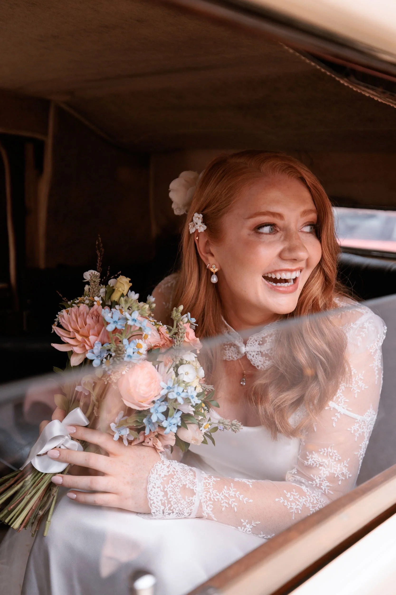 Bride Clemmie smiling with her bouquet as she arrives at Windsor Castle