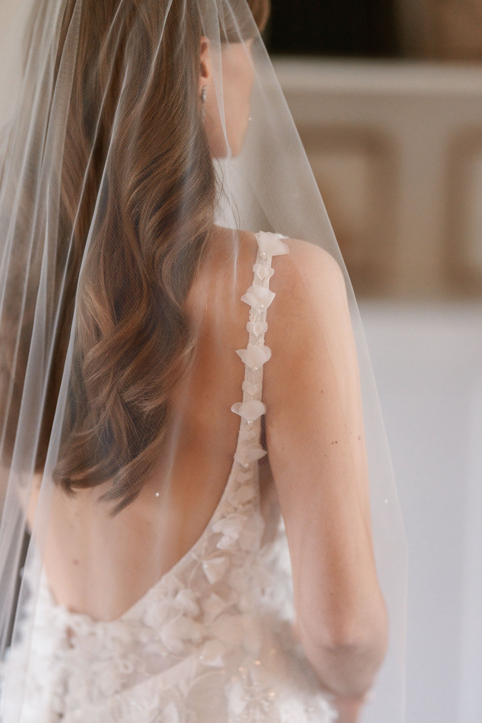 Detail of the back of a bride's wedding dress, in the Head Gardener's Cottage at Middleton Lodge