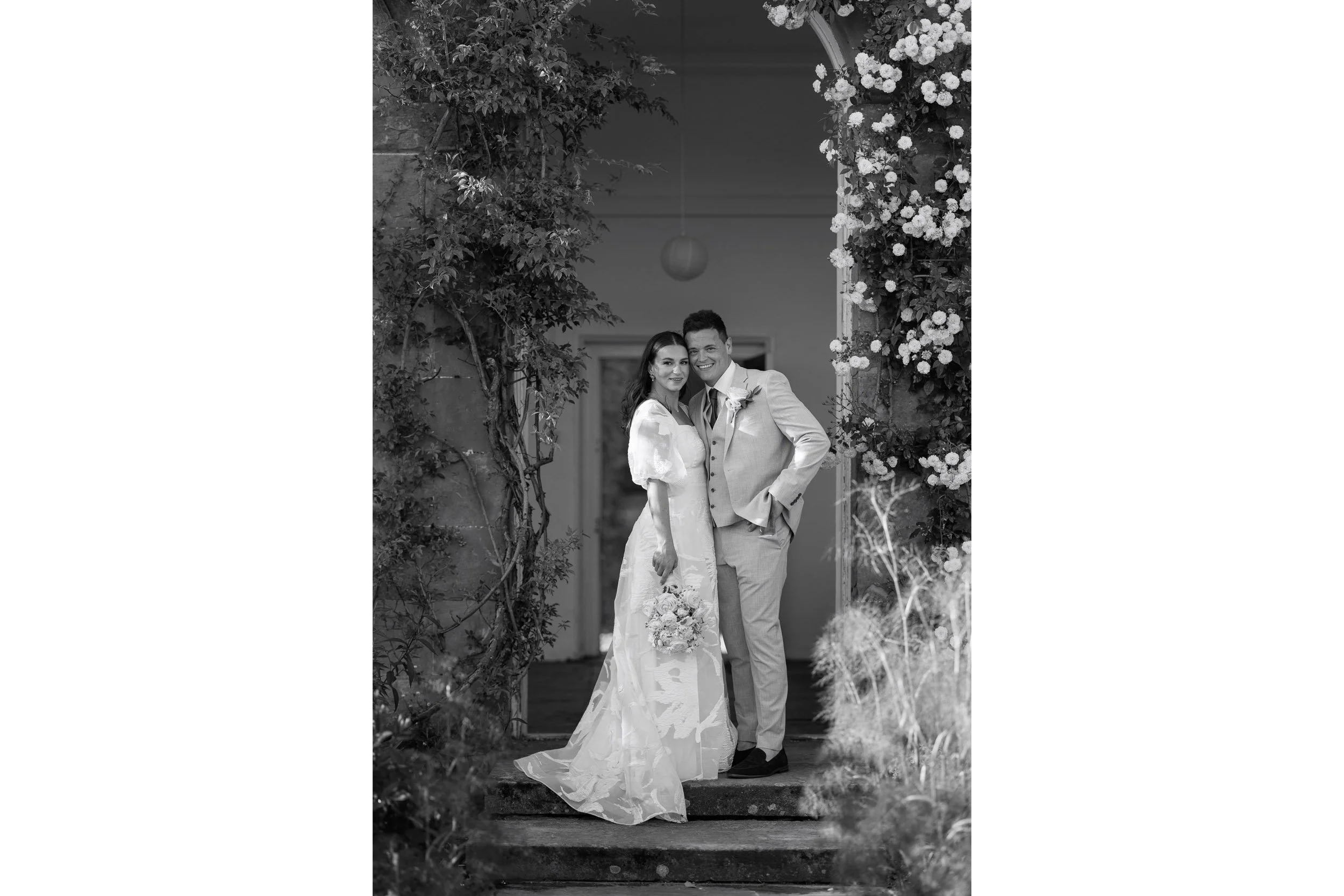 Lara & Elliott stand for a portrait at Norton Conyers at sunset, during their luxury Yorkshire wedding.