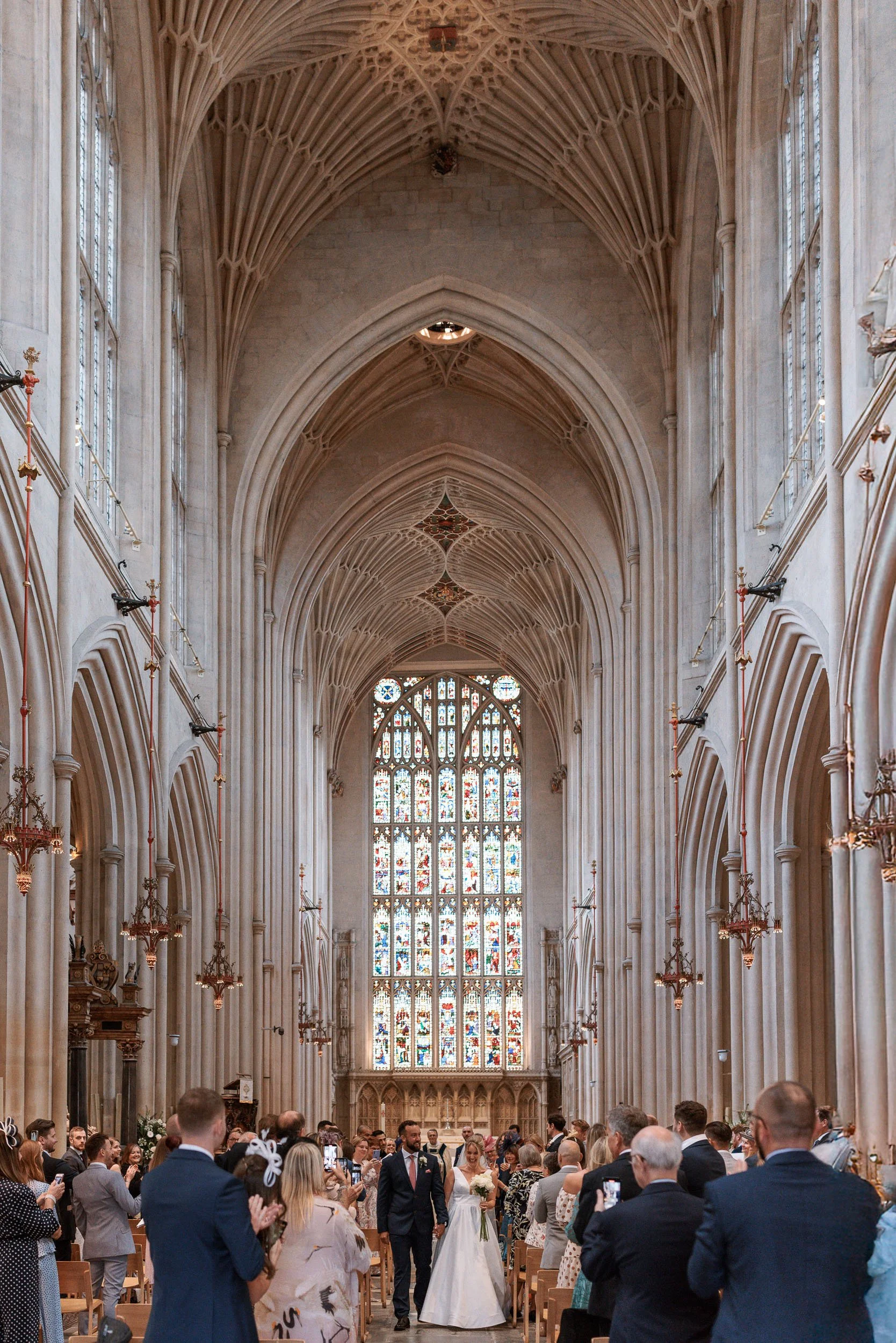 Bride and groom photographed in the historic surroundings of Bath Abbey, Somerset.