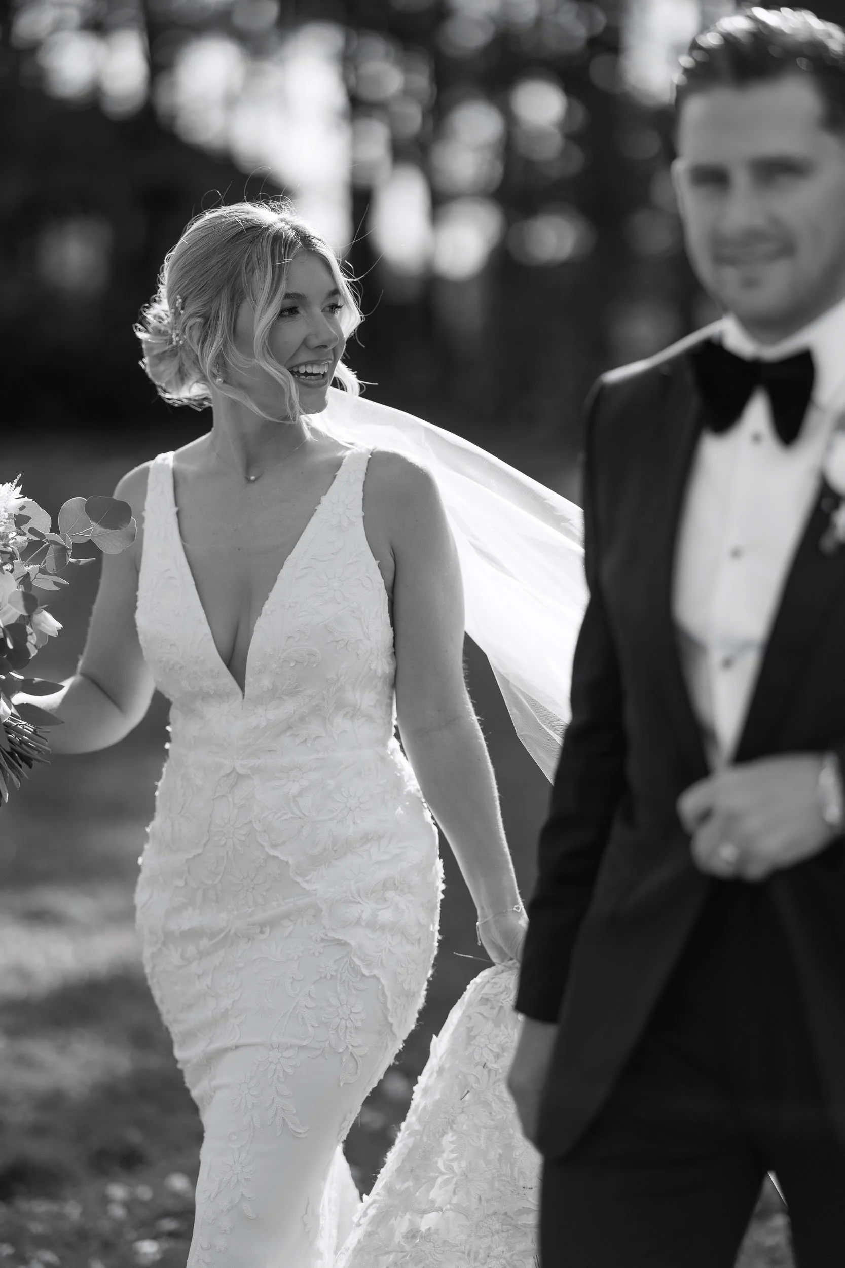 The wedding couple walk between photos at Bunny Hill Farm, York