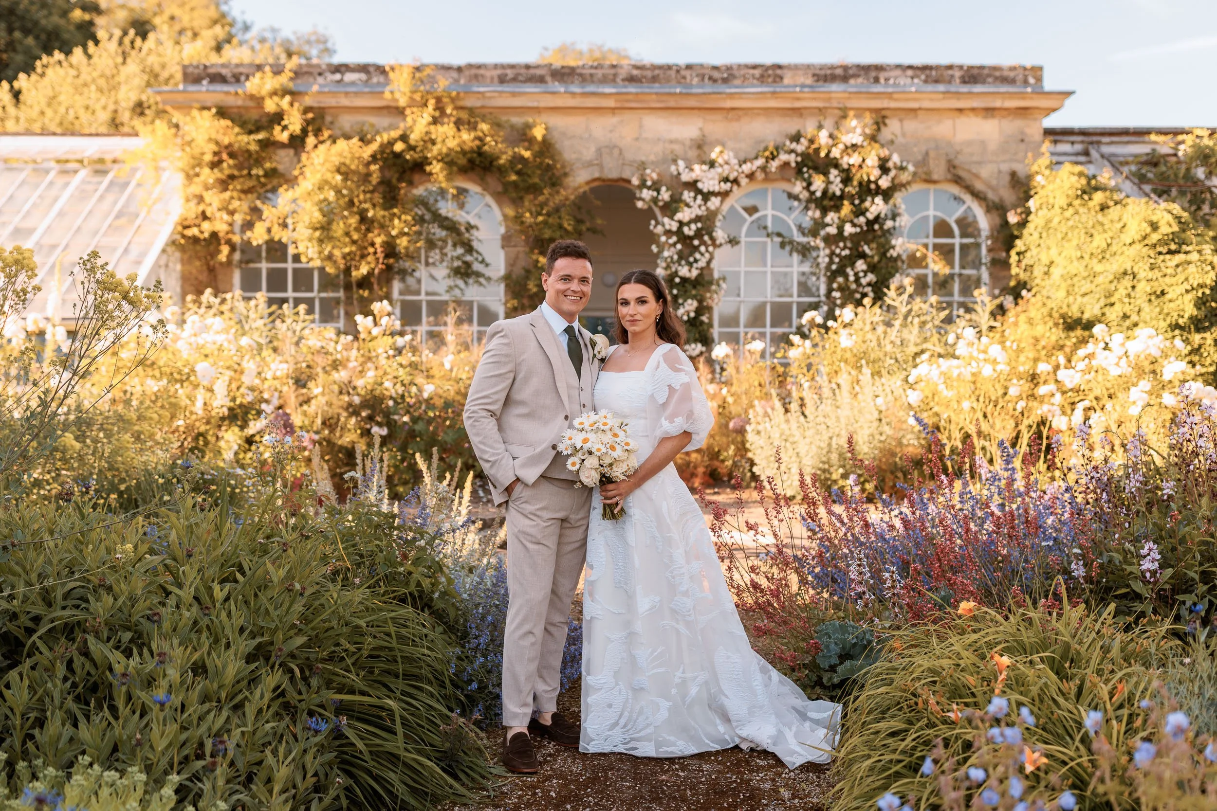 Wedding portrait amongst the flowers in the beautiful gardens of Norton Conyers, a historic country house in North Yorkshire.