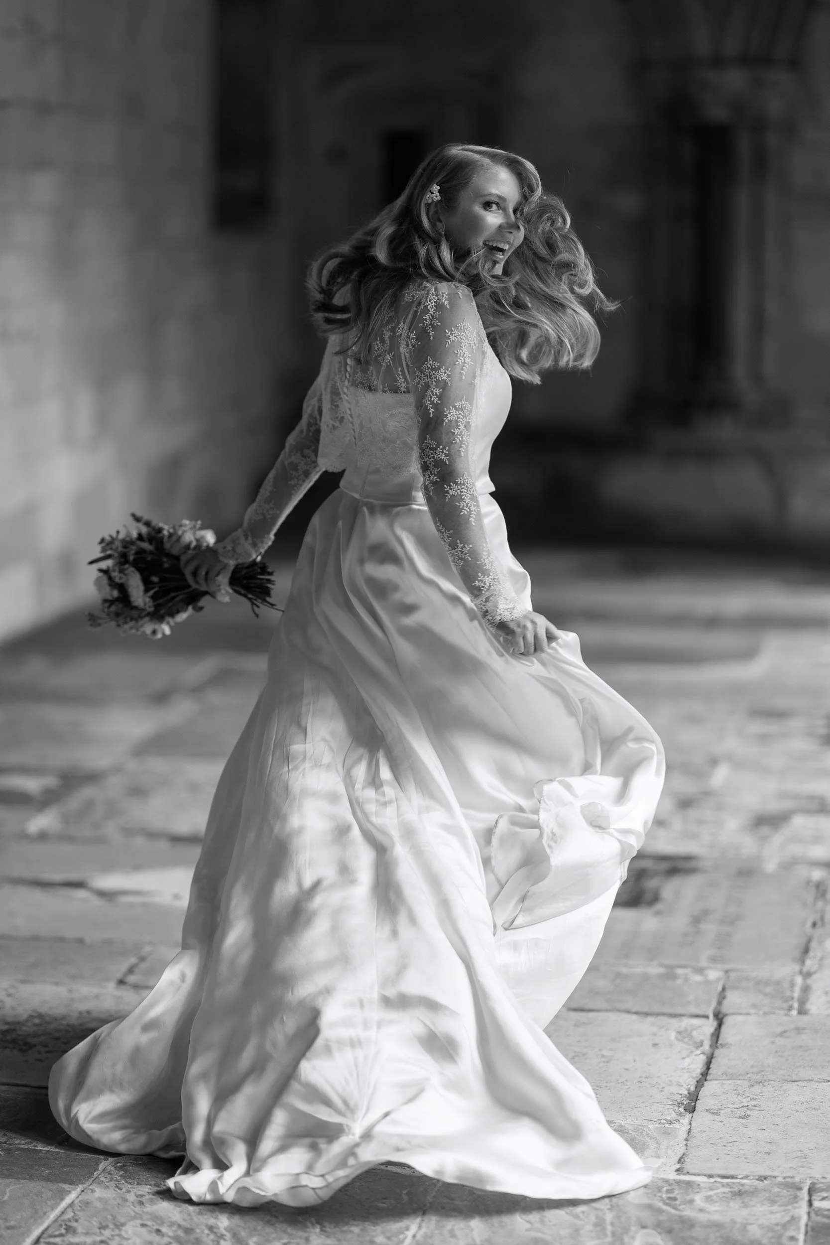 Bride looking back while walking through the Cloisters at Windsor Castle