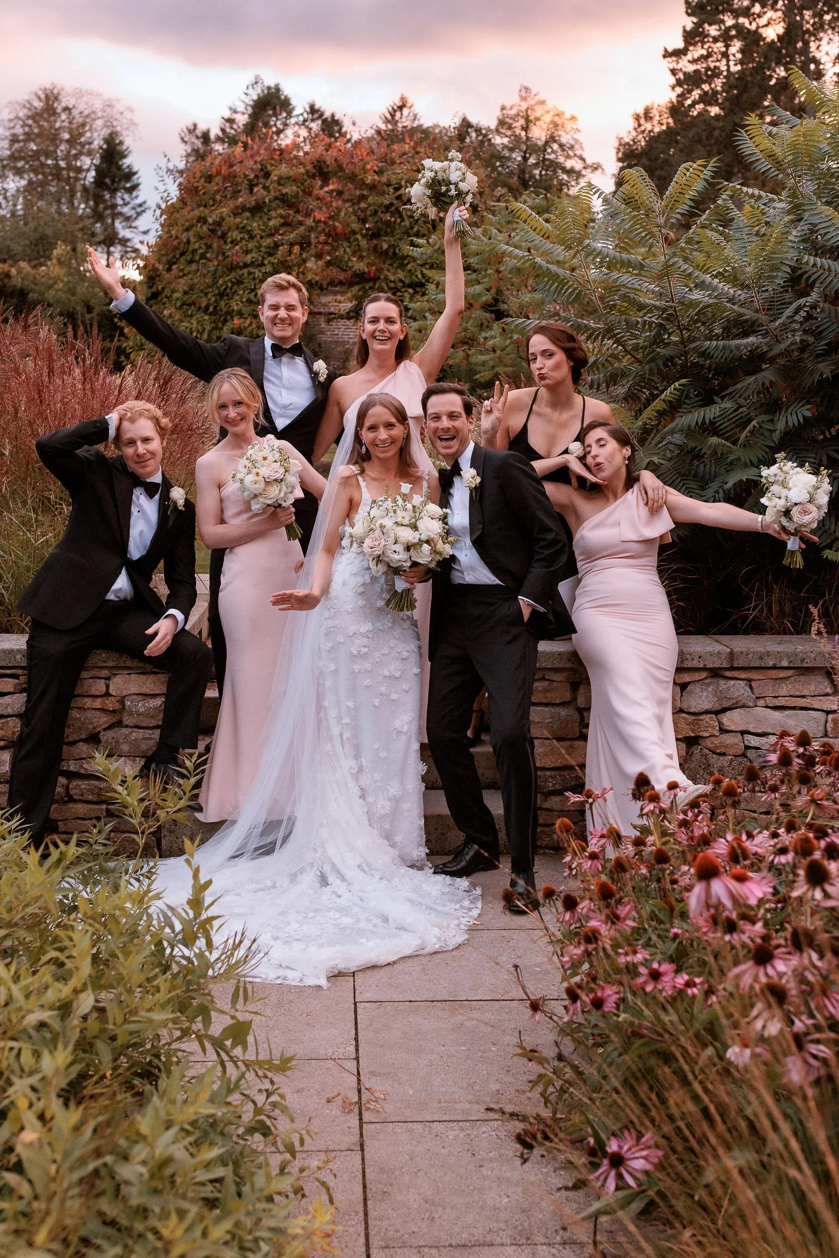 Newlyweds celebrating with friends in the gardens at Middleton Lodge.