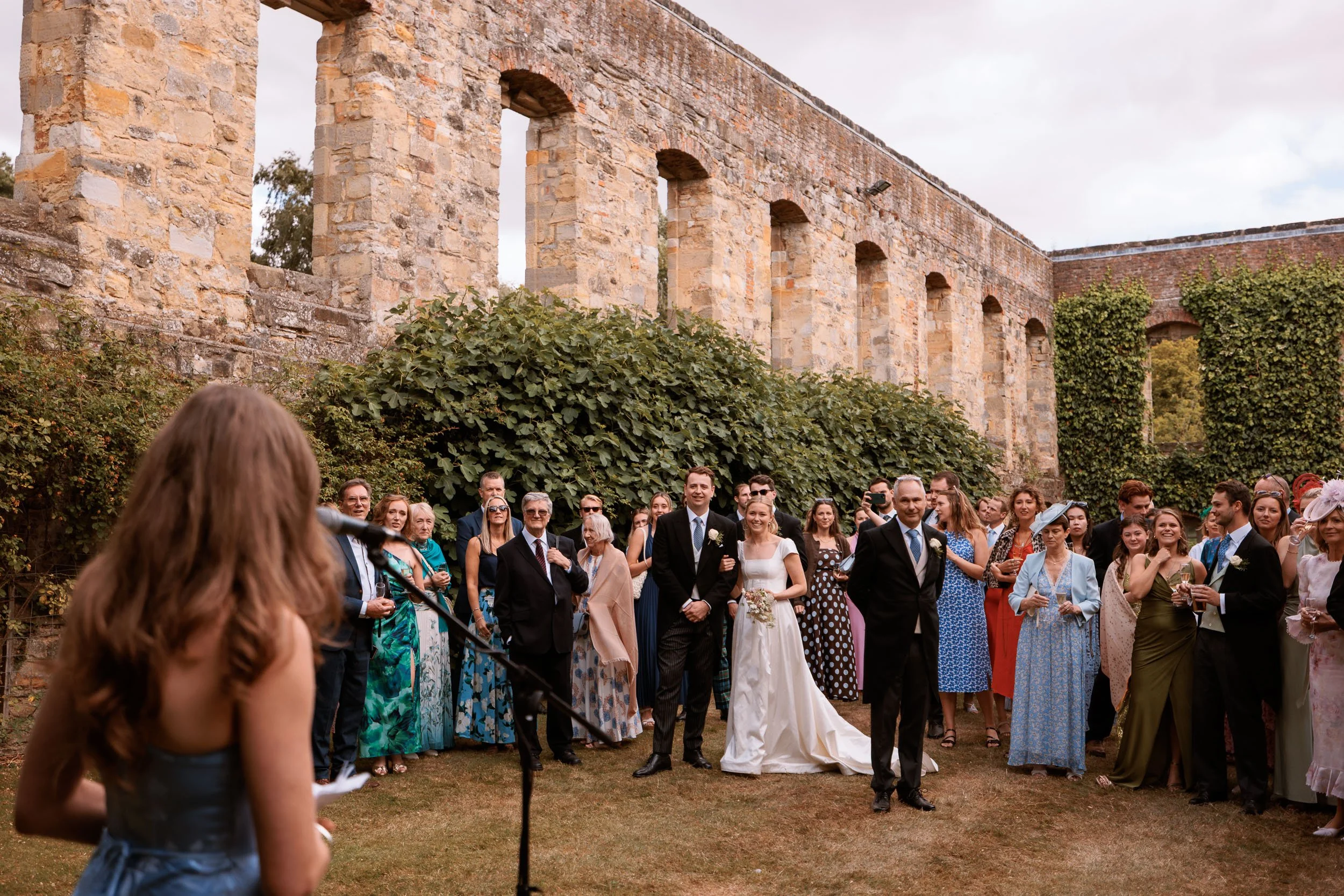 Bride, groom and wedding guests gathered among the historic stone ruins at Newburgh Priory in Coxwold, North Yorkshire.