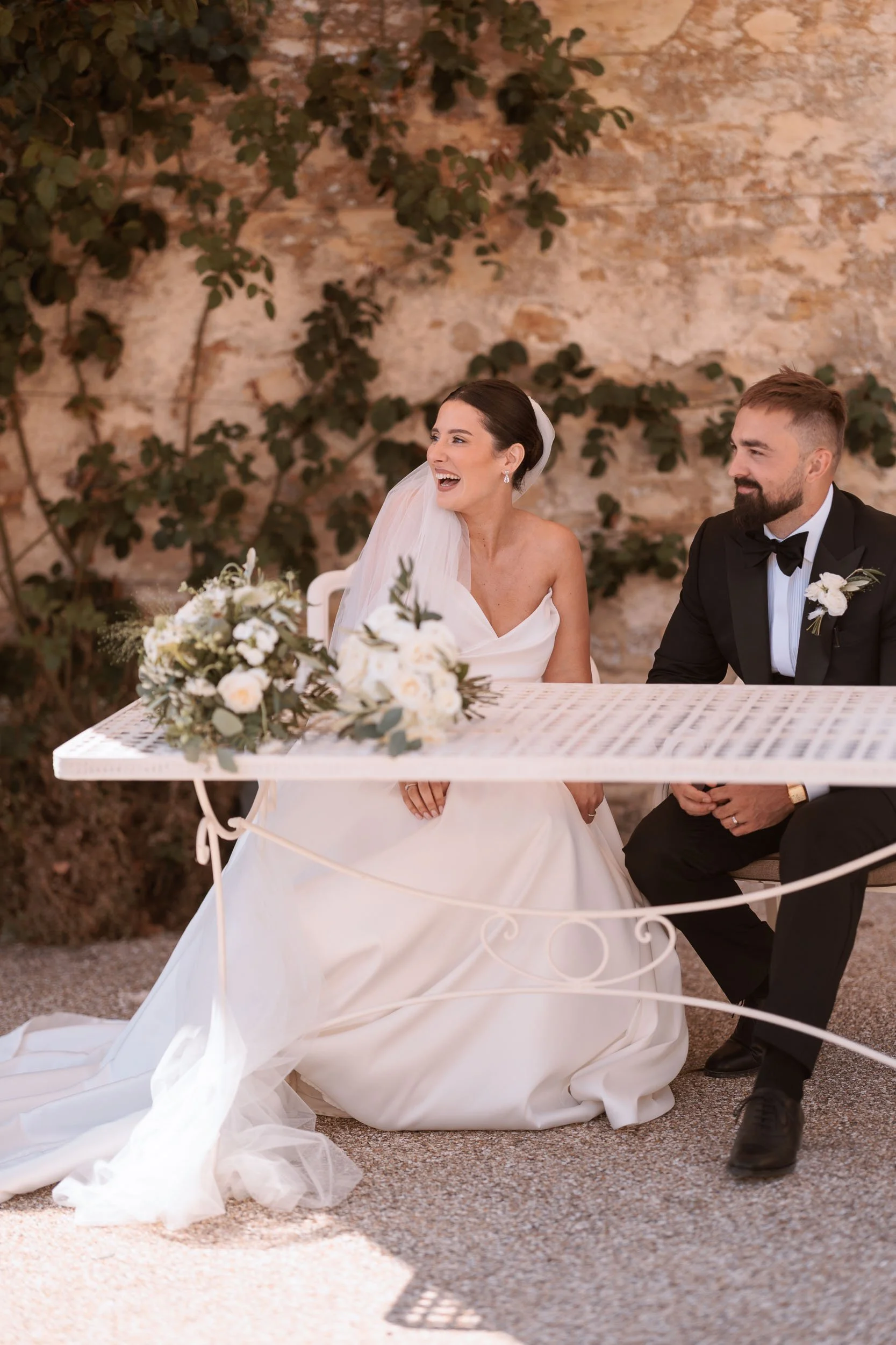Bride laughing with her groom during their wedding celebration at Caswell House in the Cotswolds.