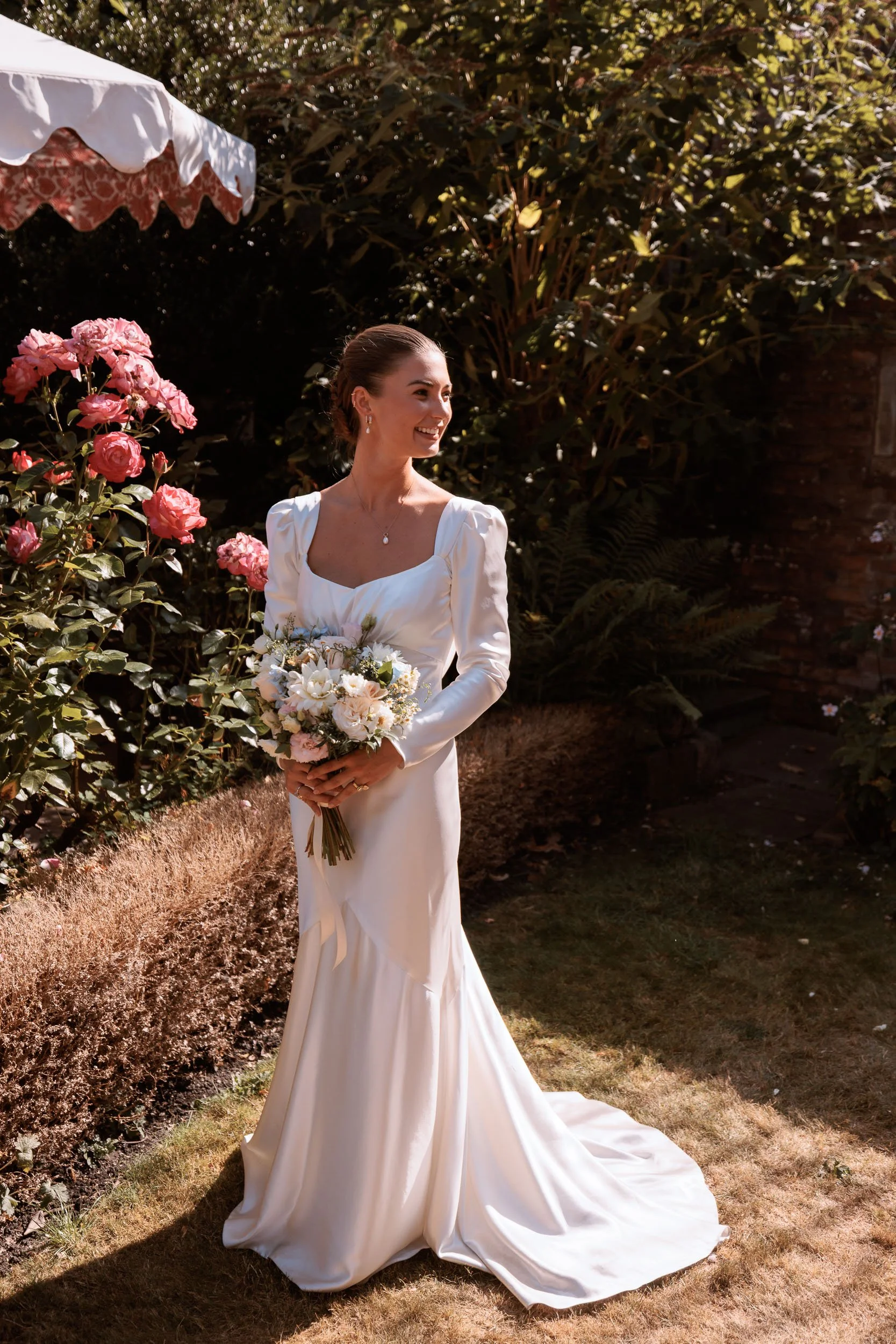 Bride holding her bouquet in a garden during her wedding day