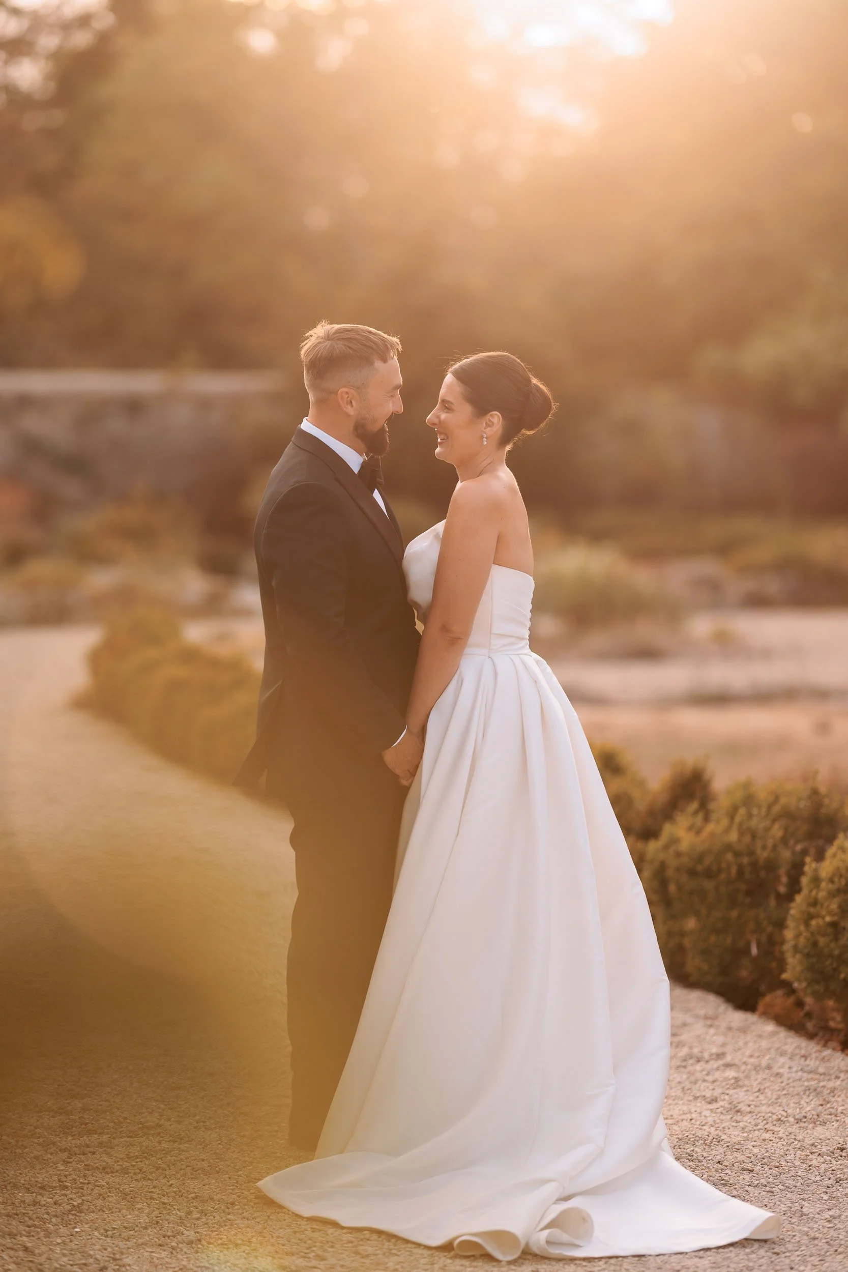 Romantic golden-hour wedding portrait of a bride and groom together in the grounds of Caswell House, Oxfordshire.