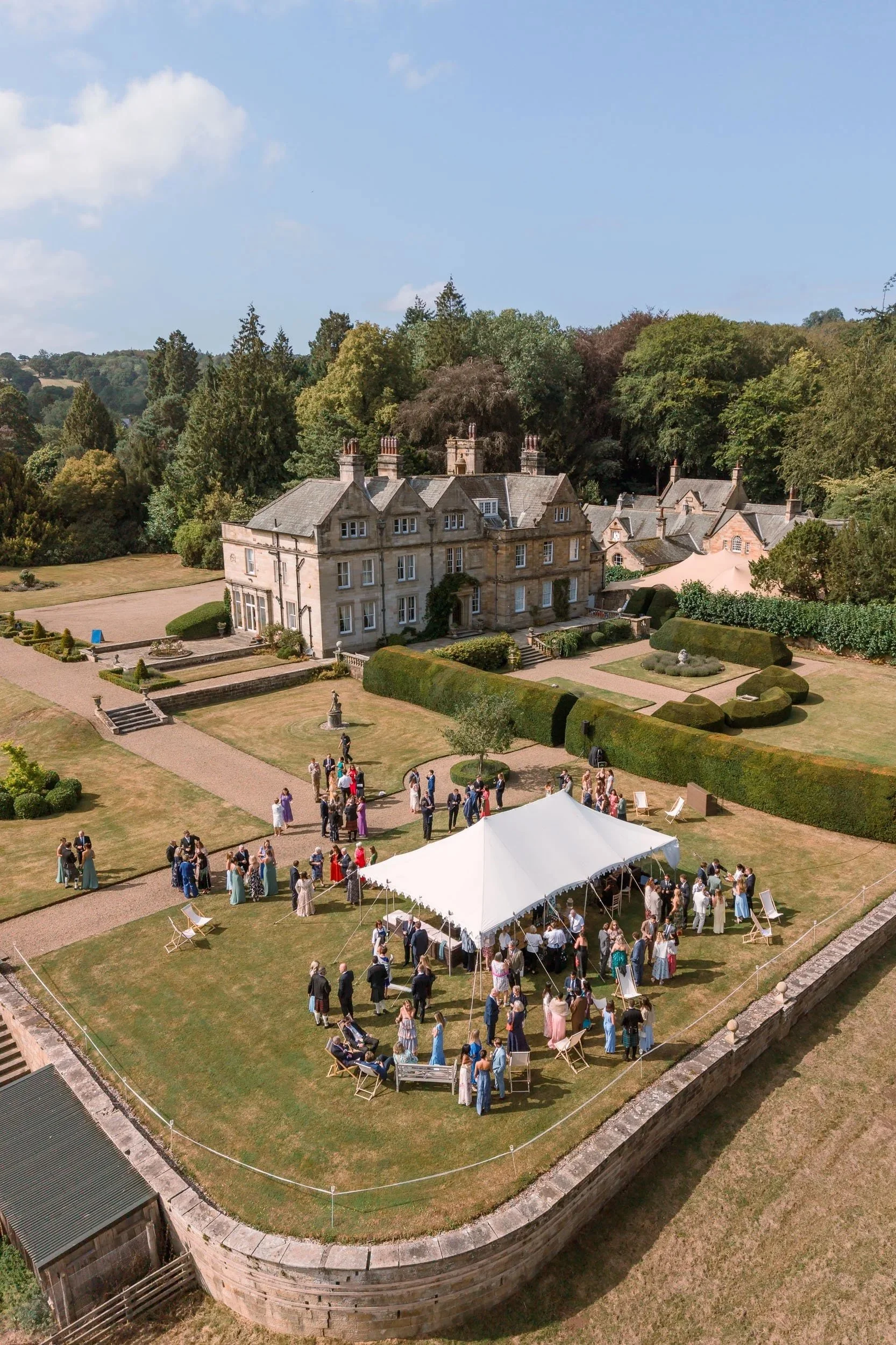 Aerial view of a wedding celebration at Egton Manor, showing the historic country house, gardens and outdoor reception in the North York Moors.