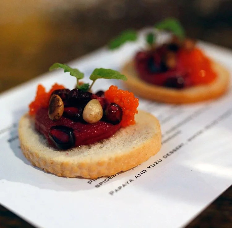 Beetroot cheese on biscuit, pine nuts, pomegranate
