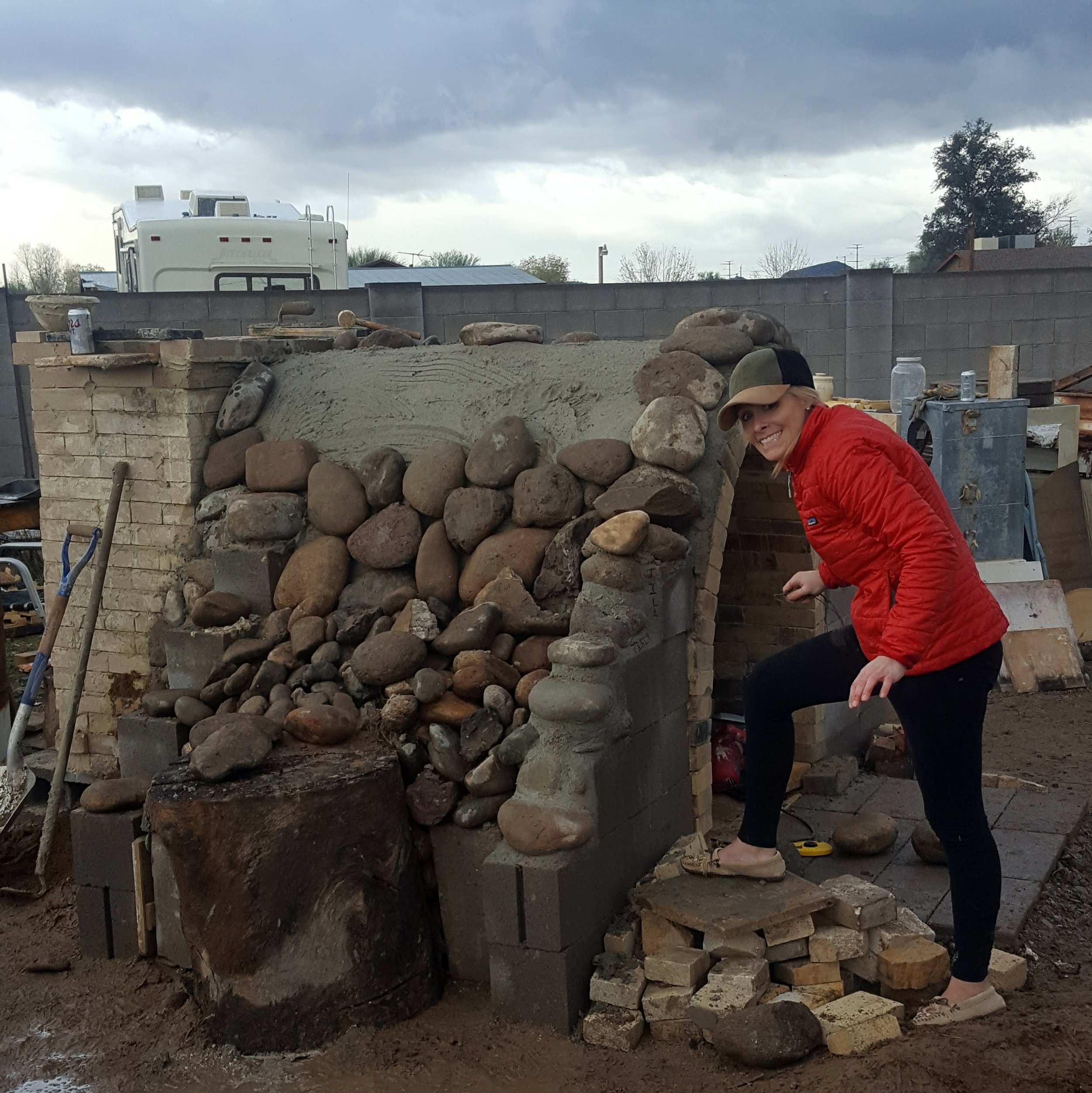 Tracy signing the kiln :) We covered the kiln arch with castable, and while it was still wet we placed all these large river rocks over it. 