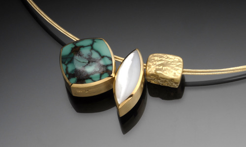   Set of three sliding pendants. Left to right:  Plain nature carved nugget in 18K yellow gold. Width 0.4" Height 0.2" Depth 0.2"  N192 Reversible marquis pendant in 18K yellow gold with moldavite and mother of pearl. Both sides of this pendant are i