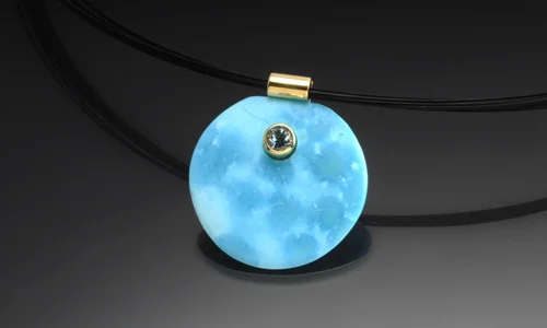   Free form stone pendant in 18K yellow gold. Turqoise with 4.5mm faceted aquamarine accent. Width 1" Length 1" Depth 0.25"     