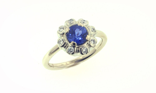   Engagement ring in 18K white gold with diamonds and center sapphire. Band width approximately 0.1" 
 Please feel free to contact us for center stone options  