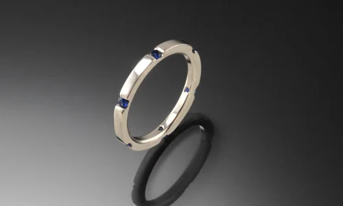   Wedding band in 18K white gold and blue sapphires. Width approximately 0.15"     