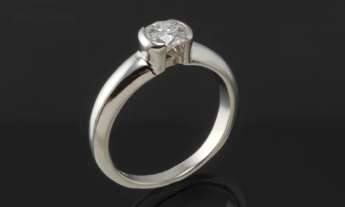   Faux tension set engagement ring in 18K white gold and center diamond. Band width approximately 0.15" 
 Please feel free to contact us for center stone options  
