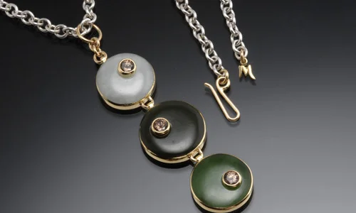   Sterling silver and 18K yellow gold pendant with white and green jade and mocha zircons  