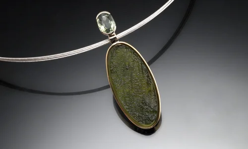   14K yellow and white gold pendant with natural surface moldavite over mother of pearl and faceted moldavite accent  