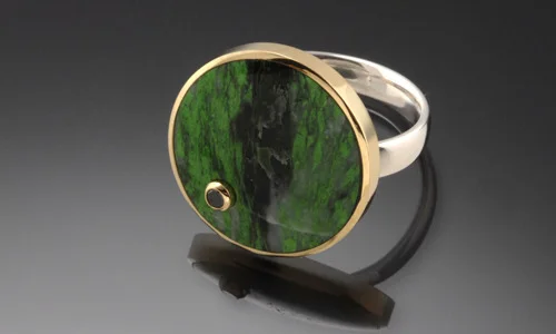   Inlay ring in 18K yellow gold, sterling silver, maw-sit-sit and 2.5mm faceted black diamond accent. Diameter 0.75" Shank width 0.2" ﻿  