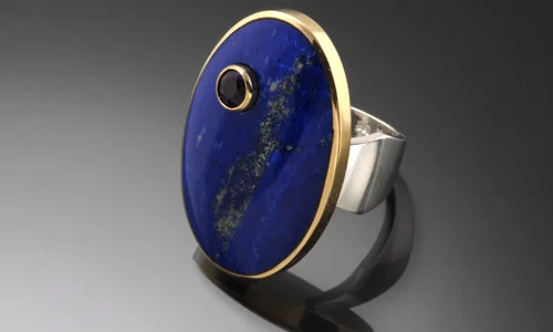   Inlay ring with 18K yellow gold, sterling silver, lapis and 4.5mm faceted amethyst. Height 1.25" Width 1" Shank Width 0.2" - 0.4" ﻿  