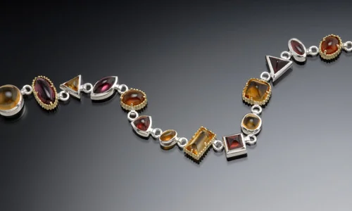   Custom sterling silver and 18K yellow gold bracelet with garnet and citrine cabachons. Width 0.4" Length 6.5" Depth 0.2"﻿  