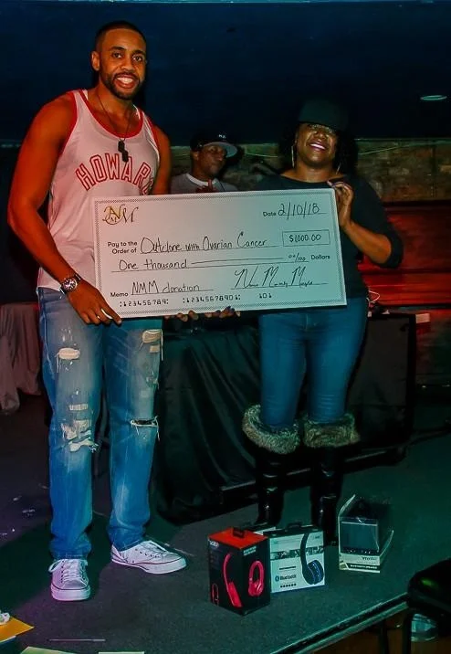 Timothy Nurse presents OWOC with a check for $1,000. 