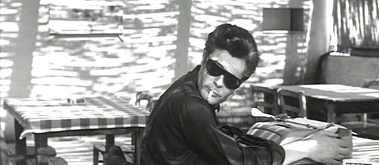 La Dolce Vita Marcello notices the "Umbian angel." The open cabana style restaurant features a protective skin of radiant light - the only moment that we see him working as a writer.