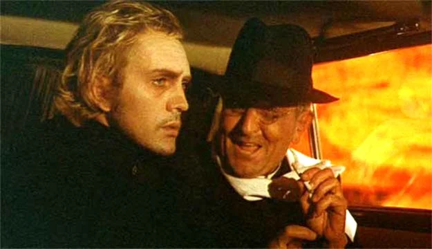 Toby Dammit Toby is instructed by the priest/producer that he is to make a "Catholic Western." Note the cigarette and the openly sybaritic attitude by the priest compared to Toby's ethereal, romantic, ascetic disengagement. Despite their physical proximity the two men occupy radically different psychological spaces.