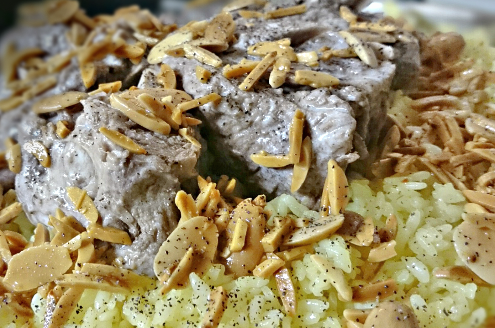 Mansaf plays a key cultural role in Jordanian traditions, served on special occasions like weddings, births, and main Islamic holidays. It is made with rice and lamb, garnished with pine nuts, almonds and parsley.