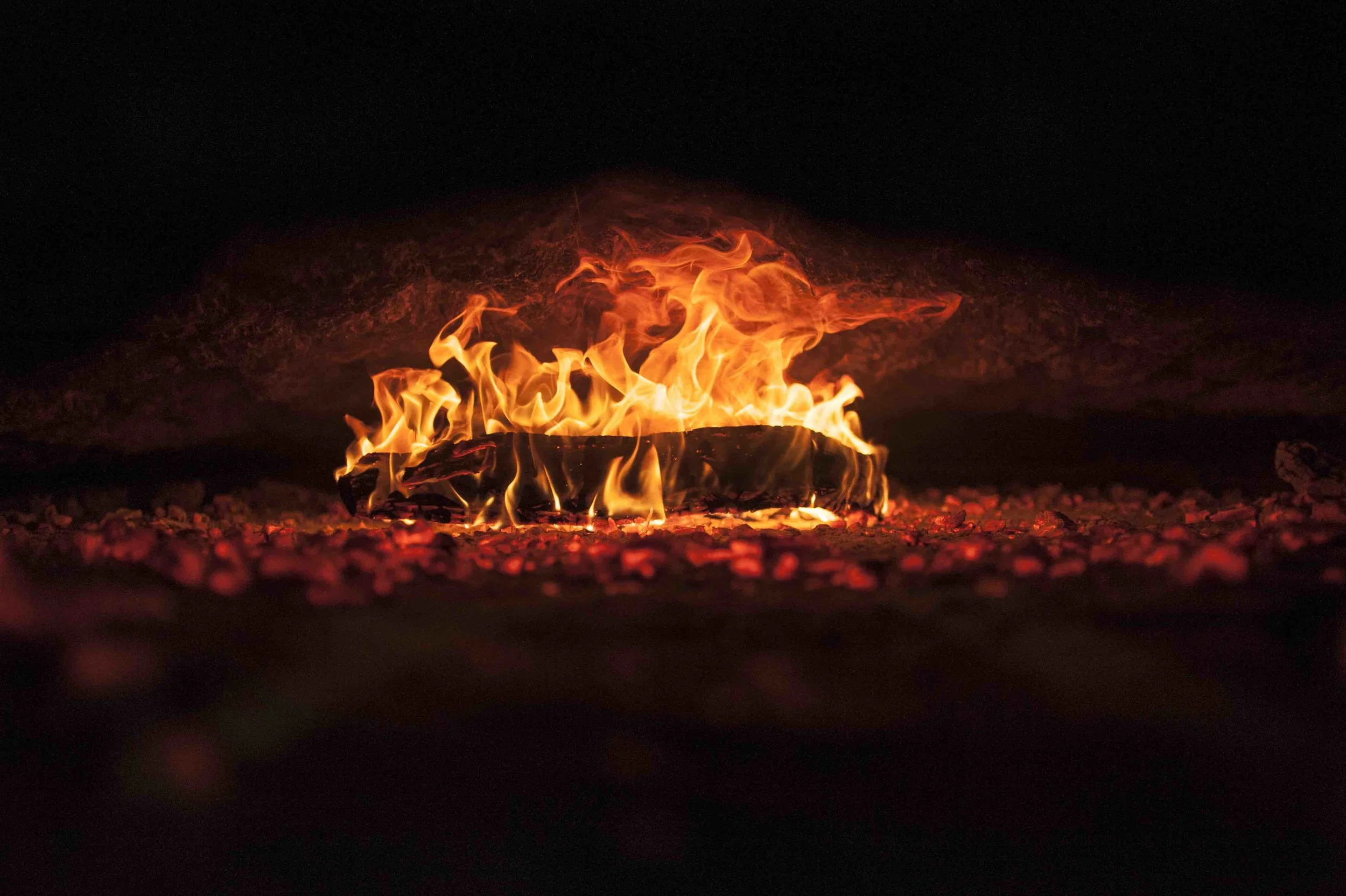 The oven, called the forn is laid by hand, layer by layer using sand, stones and glass and packed outside with clay. The cavity inside is lined with stone tiles and laterite to keep high temperatures and also to retain optimum heat. Typically dried hard wood like tamarind or jamun is used. The burning coal is spread out time to time with a wooden spatula to make sure that all corners of the oven are heated evenly. Shot in Gomez Bakery, Aquem Alto, 2017
