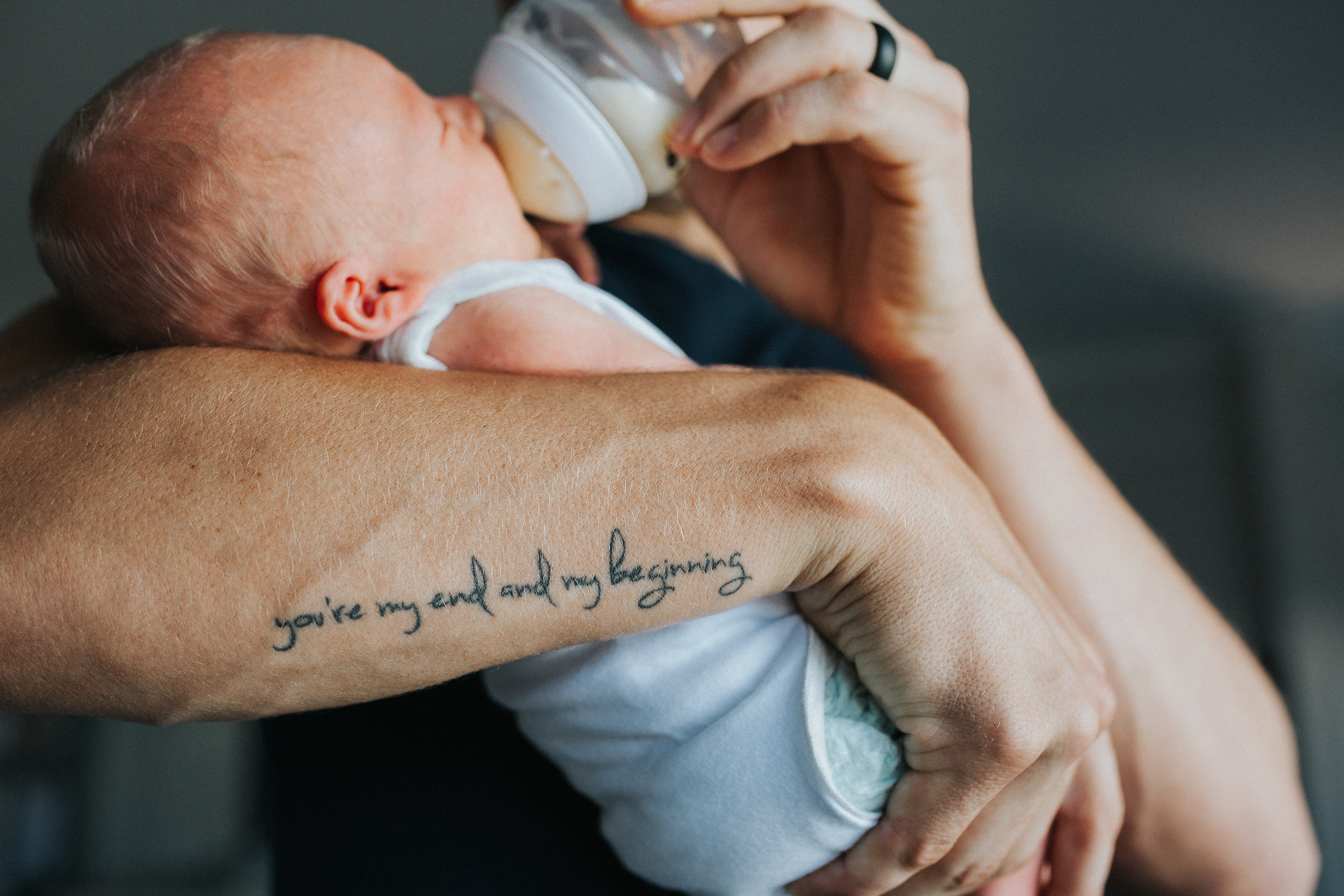 dad bottle feeding baby