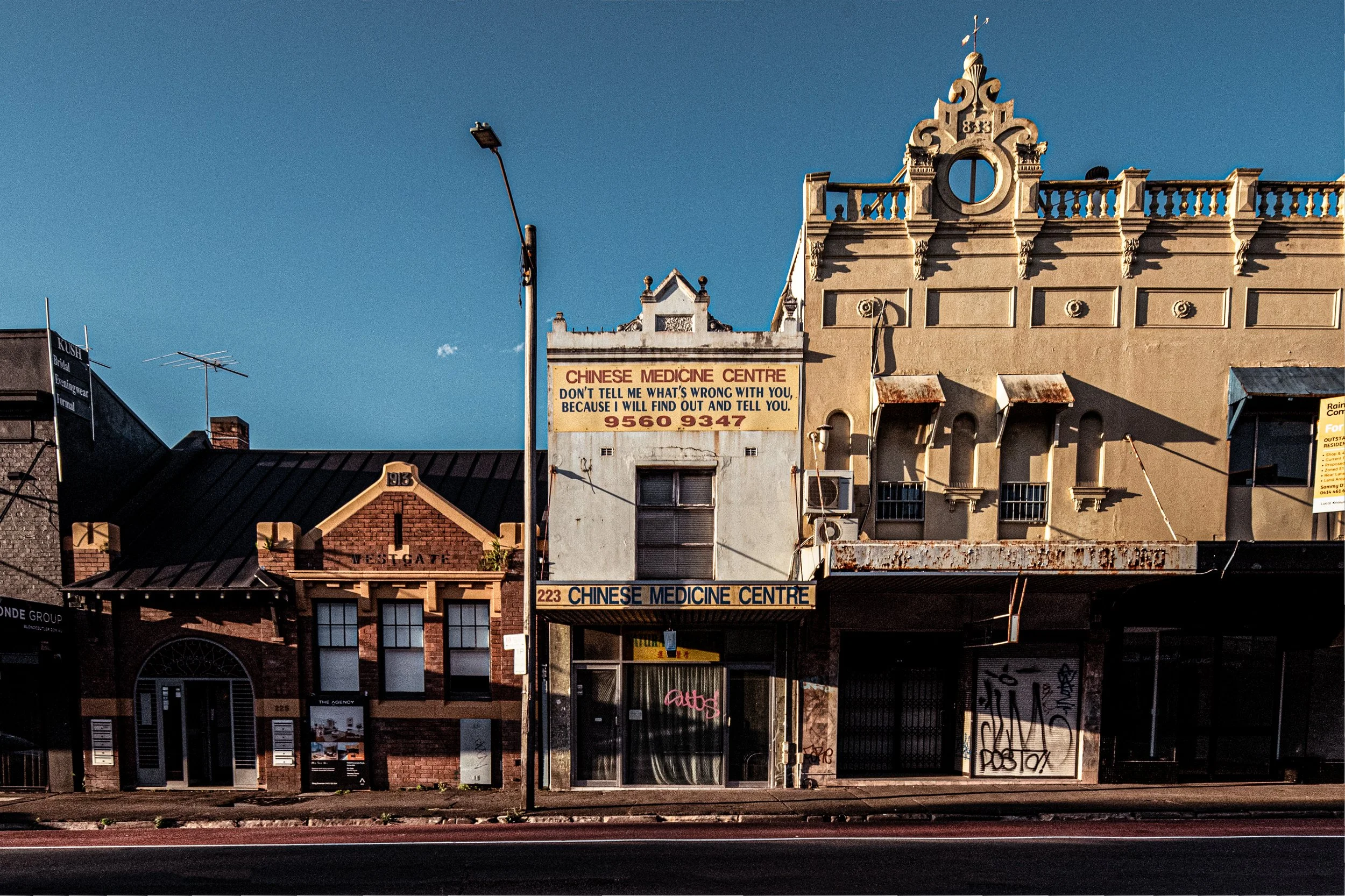  223-219 Parramatta Road, Leichhardt  This group shows three eras of the road's development. At 221-223 is an early 20th-century shop-house, known for its hand-painted Chinese Medicine Centre sign. Beside it, 219 Parramatta Road is a late-19th-centur