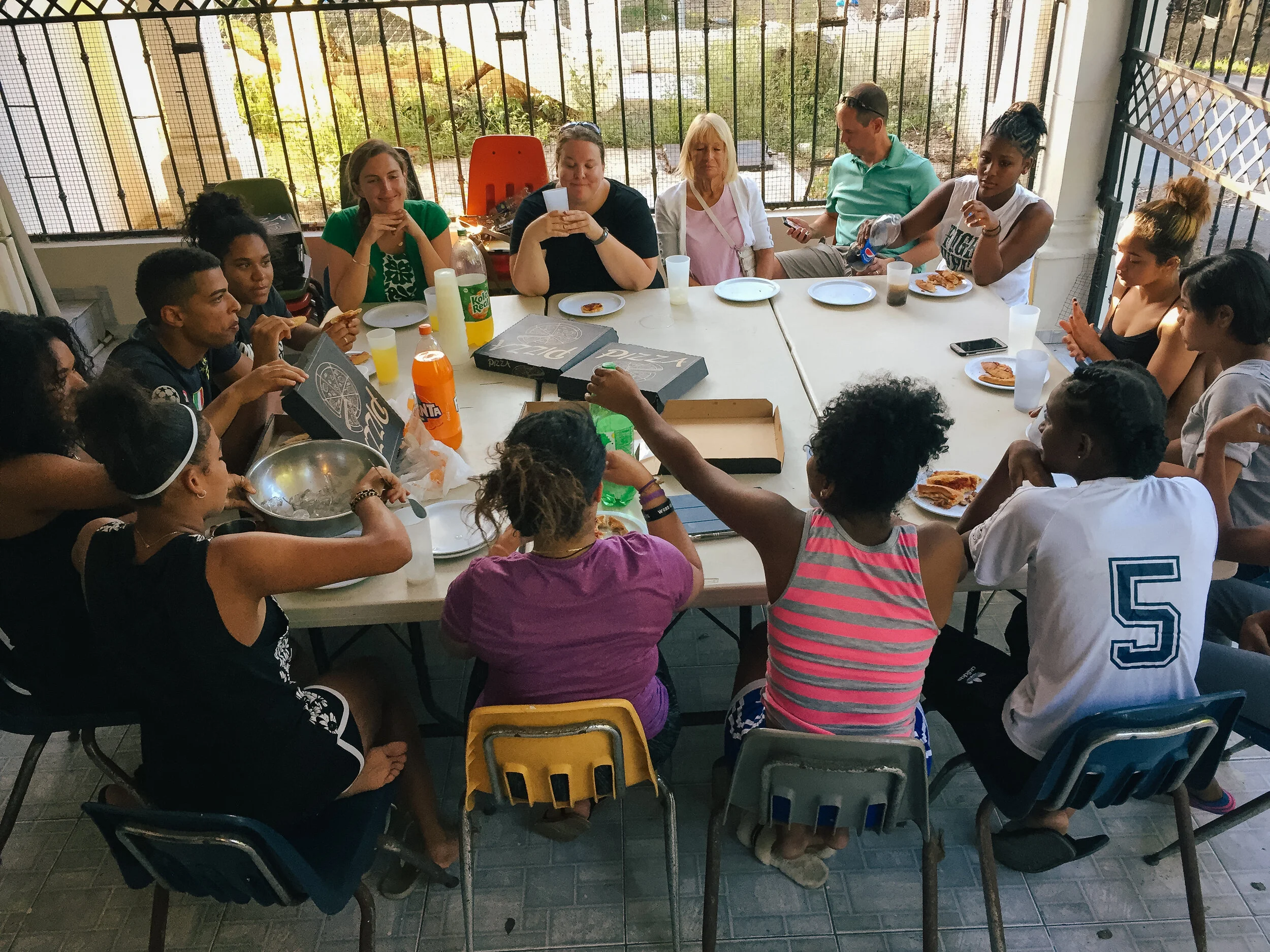 The CGI facilitators and Survivor Camp participants getting to know each other over pizza.