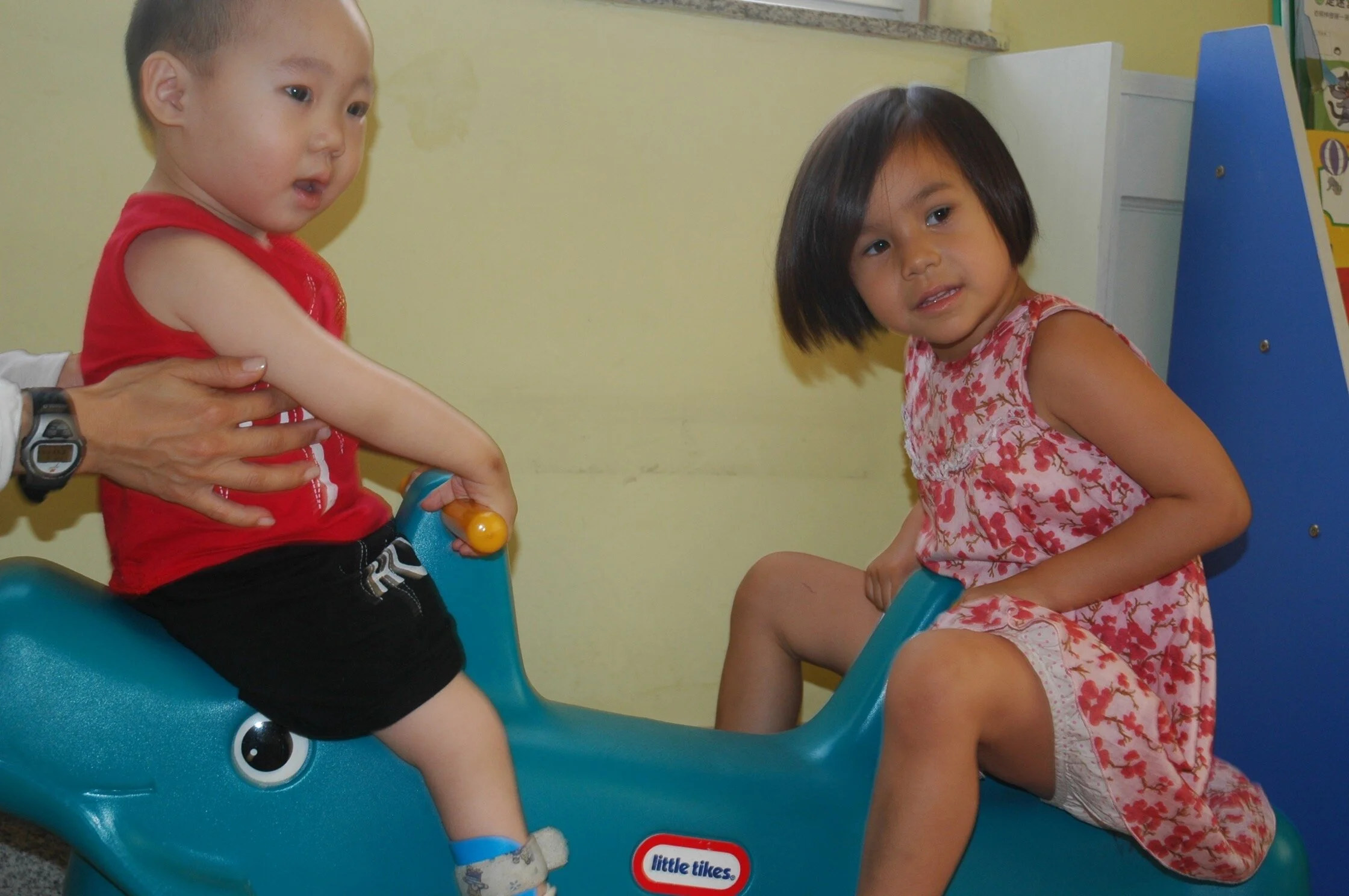 This is a picture of me with Ting Ting when I was three years old and he was just a year old.