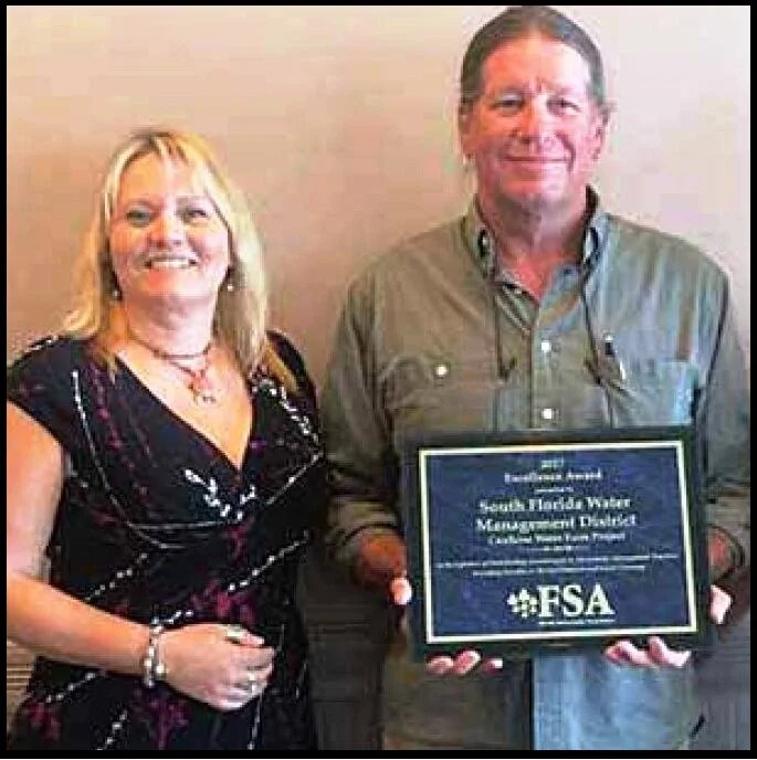 Engineer Melissa Corbett of The MilCor Group in Hobe Sound and Boyd Gunsales, lead environmental scientist for the SFWMD, receive the "2017 Excellence in Engineering Award" for the Caulkins Water Farm.