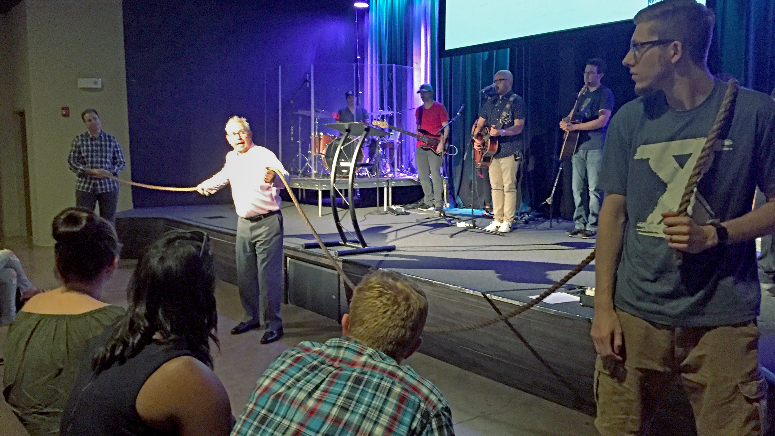 Pastor Charlie illustrates the "tow rope" of the world that pulls on us (right) vs. the "life line" that God uses to draw us nearer to him (left).