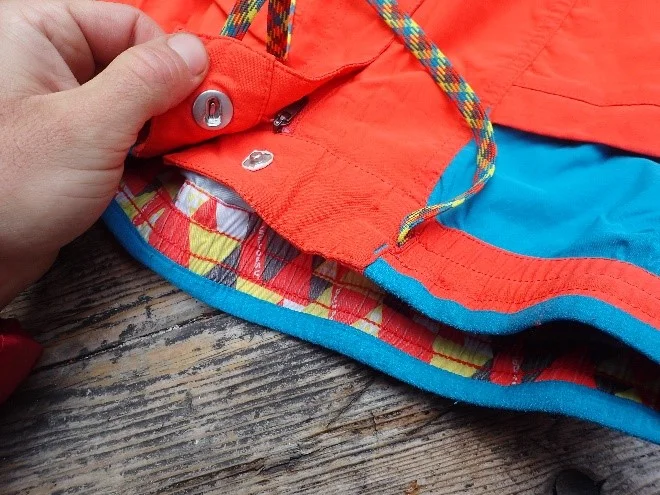 Instead of snapping, the button slides into place like a good nut placement. I find this easier to do under a harness. The stretchy shoelace drawstring keeps the pants up with minimal bulk, and the waist band is wide, low profile, and lined on the top with a padded fuzzy material, making the pants supremely comfortable under a pack or harness. The Crimpers have all 4 of these design elements, as well. Fine design features typical of LaSpo like the inner waistband pattern and “La Sportiva” inset on the waistband liner can be seen here.
