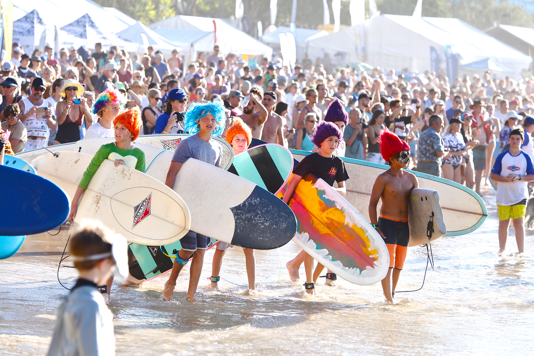 Massive crowd lines Noosa's Main Beach for the Costume Party Surf Exhibition.