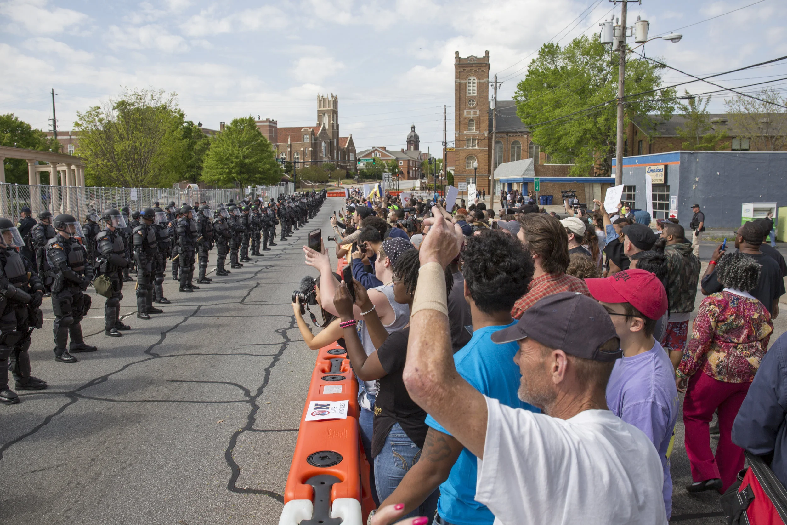 Protestors stand behind a barricade as they fight back against a gathering of neo-nazis led by the New Socialist Movement in Newnan, GA.