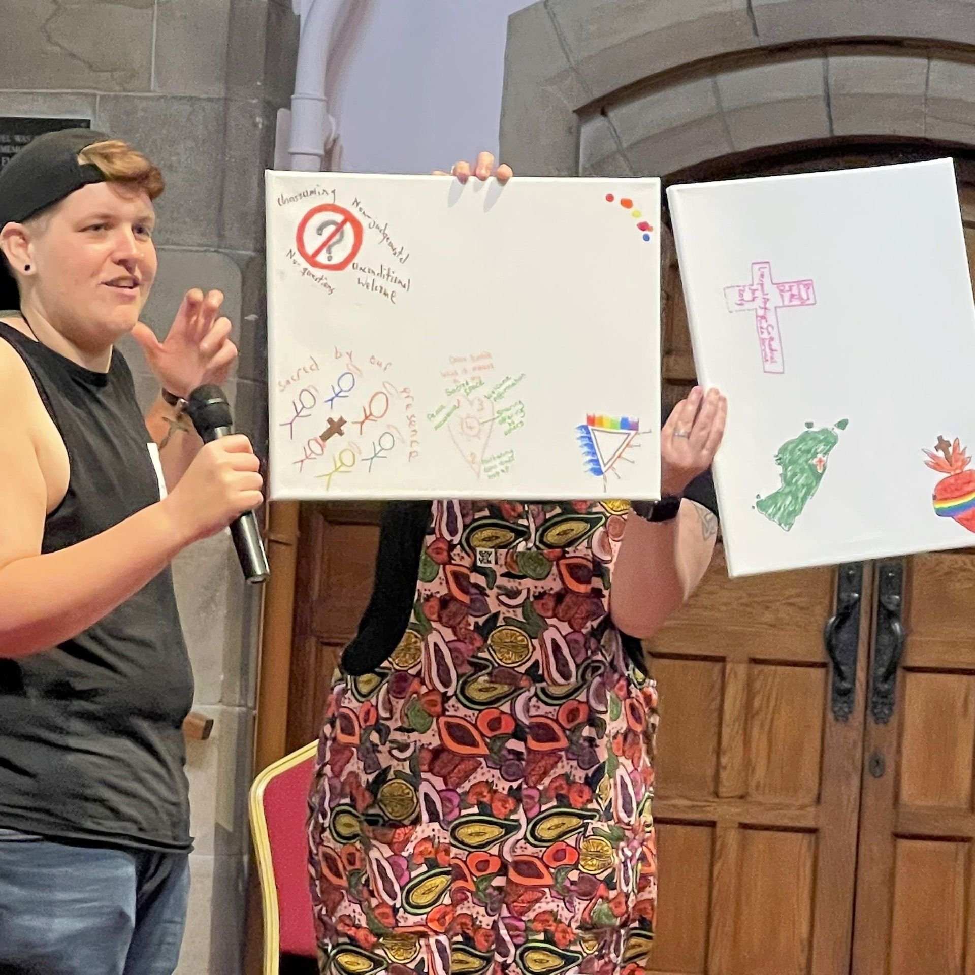  PhD student Peter Jones (left) presenting creative contributions to the ‘mapping sacred space’ breakout group at the Open Table Network national gathering in June 2022. Another person (right) holds up the creative contributions.  READ MORE.  