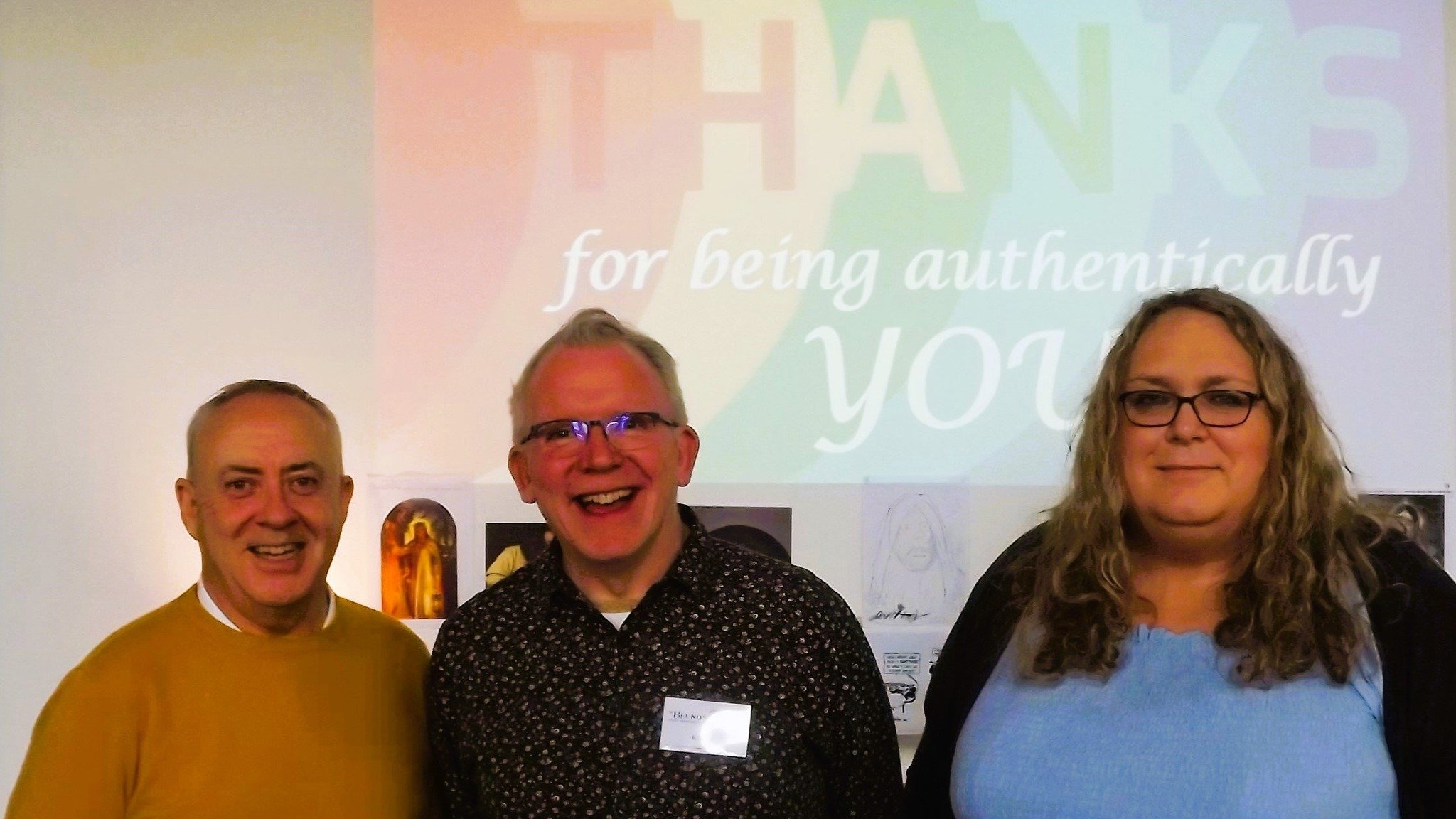  Leading a weekend retreat for LGBTQIA+ Christians in November 2022 were Frank from Quest, Kieran and Sarah from the Open Table Network. They are standing in front of a slide projected on the wall behind them which says ‘THANKS for being authenticall