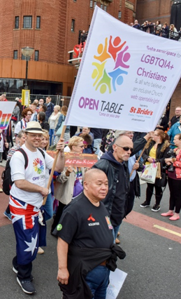 SAM (centre) volunteering as a steward at Pride in Liverpool in 2017. He did not know the Open Table community at this point.