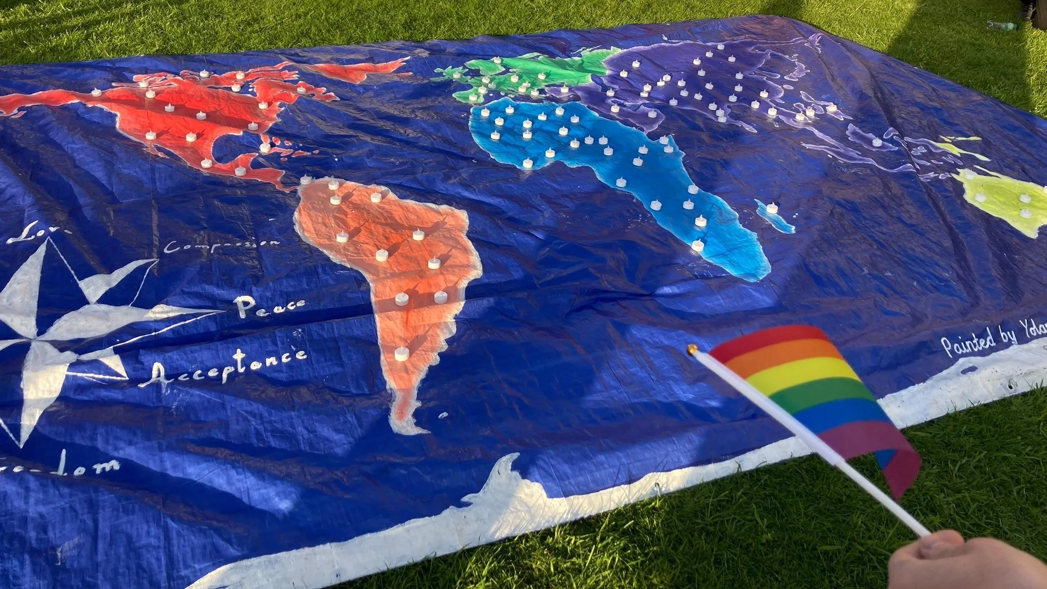  World map with six continents in the colours of the rainbow flag and LED tea lights representing countries which criminalise consenting sexual acts between people of the same sex, and countries where trans people are known to have died due to transphobia, at OTN’s IDAHOBIT vigil in May 2022.  PHOTO: Merseyside Police Chief Constable Serena Kennedy. 