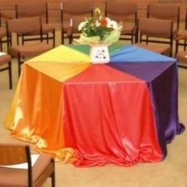  The Quaker Meeting House hexagonal table dressed in the rainbow flag to represent the spectrum of diverse beliefs and traditions 