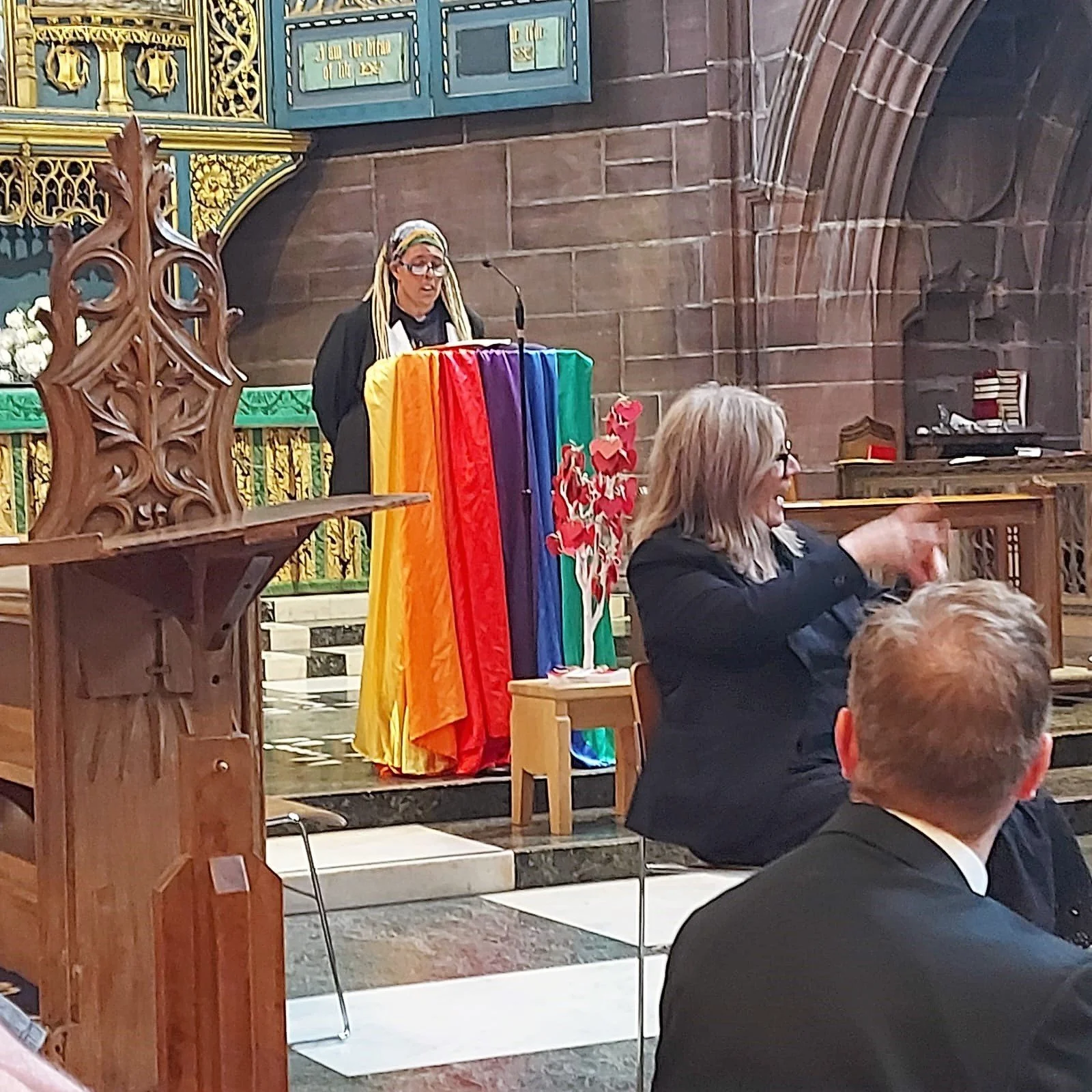 Sue speaking at the Christians At Pride service in Liverpool Cathedral’s Lady Chapel on Sunday 31st July 2022, with British Sign Language interpreter in front.