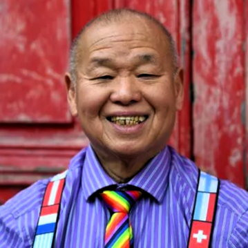  Yew Fook Sam, outside red wooden door of St Bride's Liverpool, where he has attended the Open Table community for many years. 